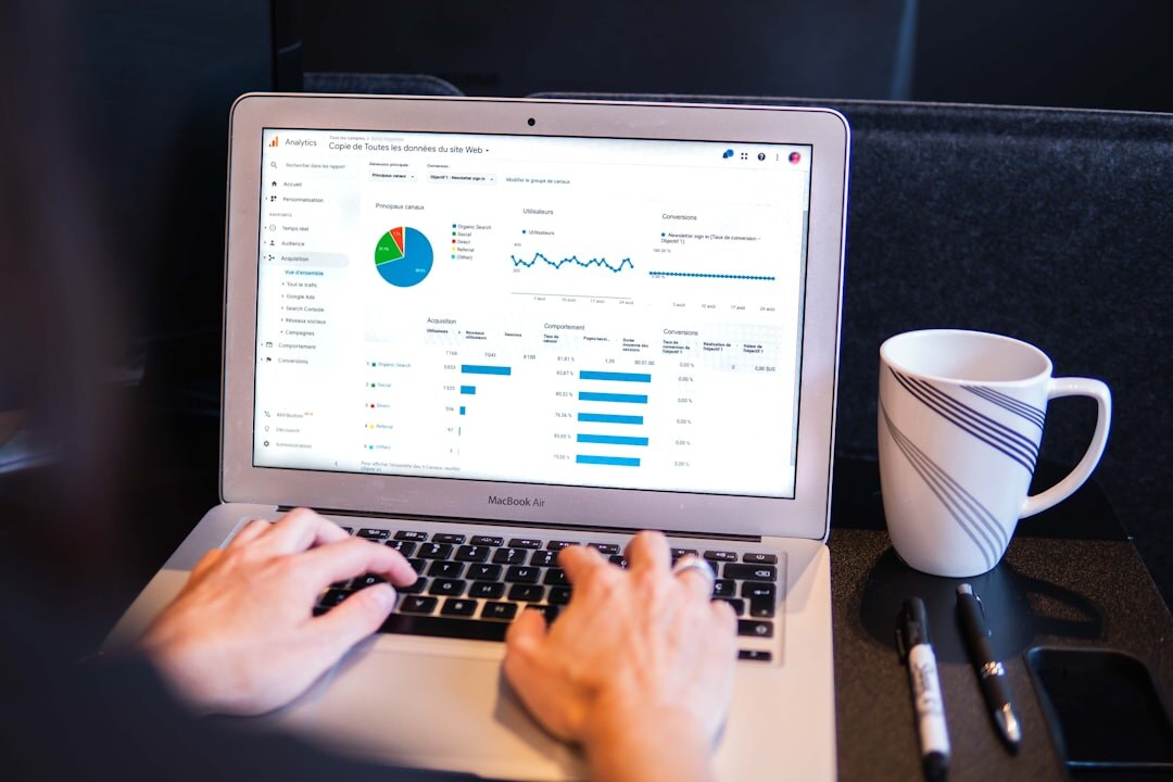 Close up of hands typing on a laptop showing colorful marketing charts